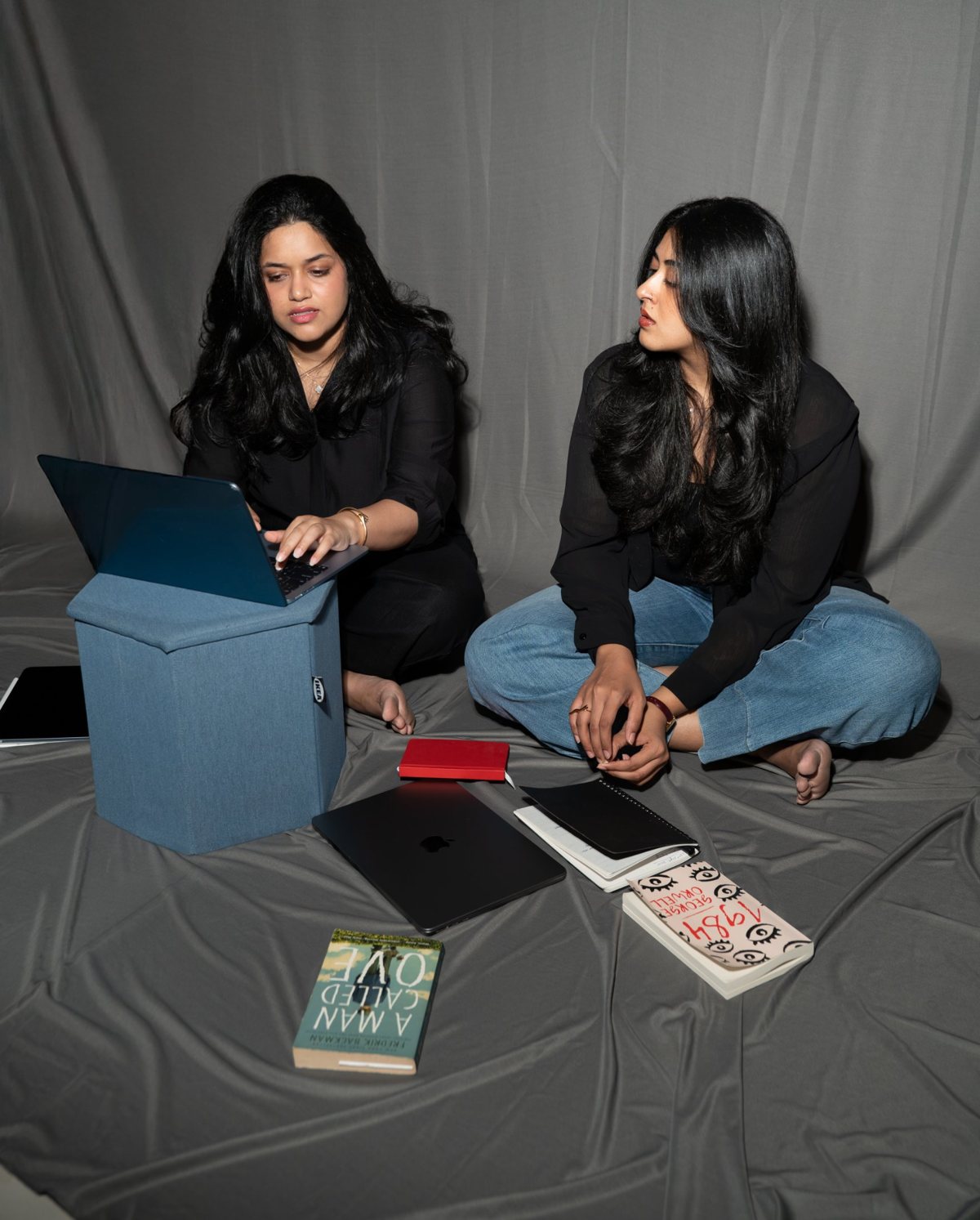 Lakshmi and Kruthika, the founders of Mollin, working together on a laptop and notebook