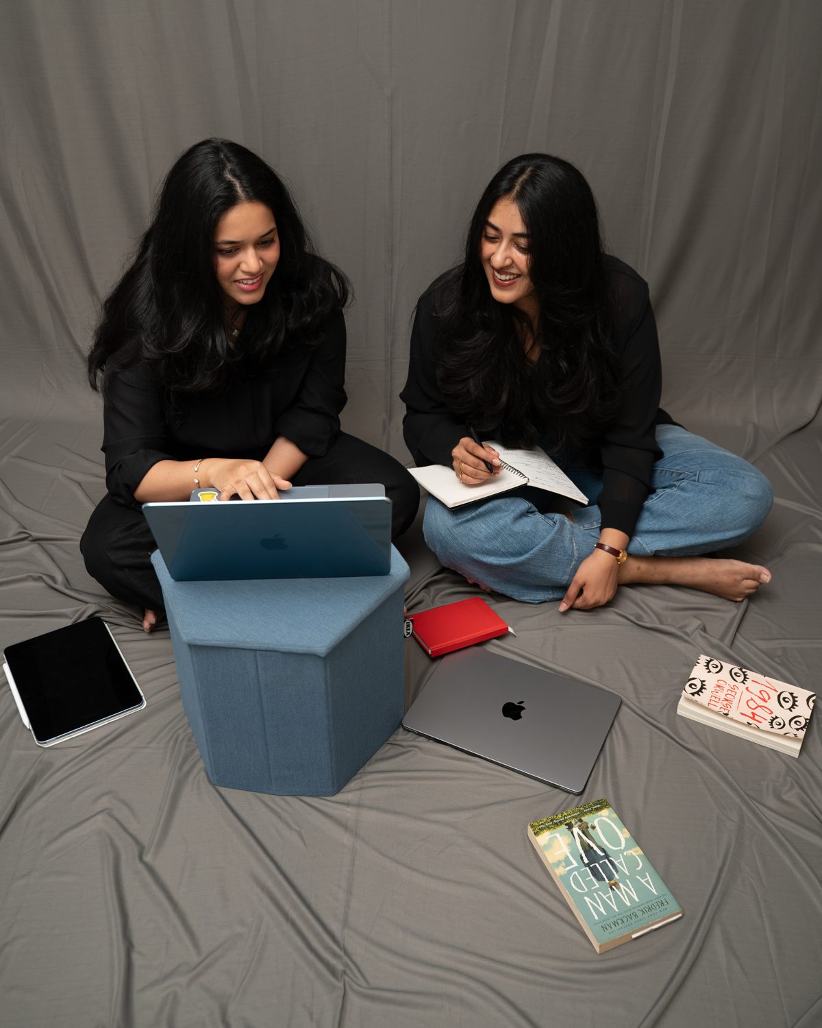 Lakshmi and Kruthika, the founders of Mollin, working together on a laptop and notebook